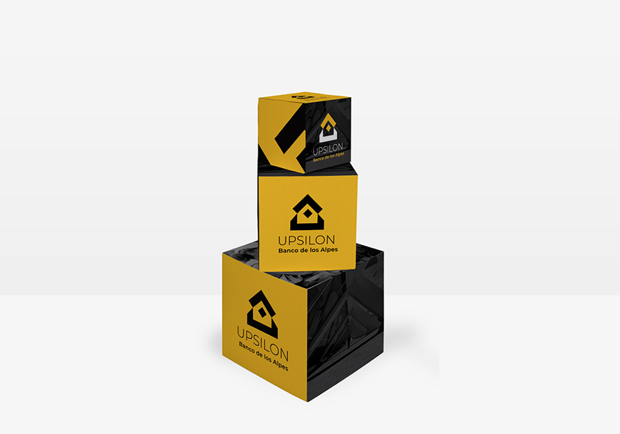 3 cubos de cartón de distintos tamaños apilados con diseño en colores amarillo y negro para ferias y eventos
